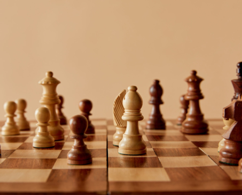 selective focus of wooden chess on board and beige background